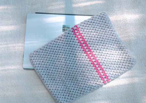 crochet puff stitch laptop case on top of surface pro laptop