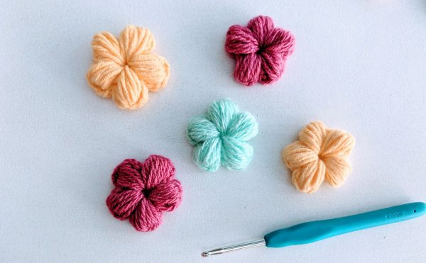 crochet flowers in yellow, pink and blue