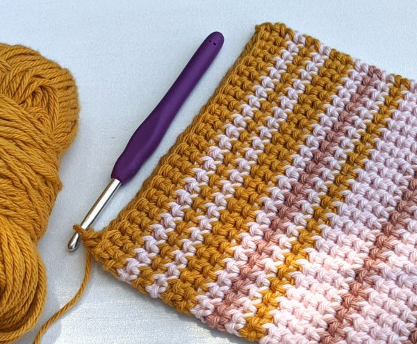 potholder with stripes with crochet hook