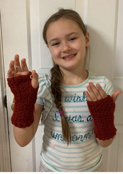 a girl wearing red-brown coloured fingerless gloves