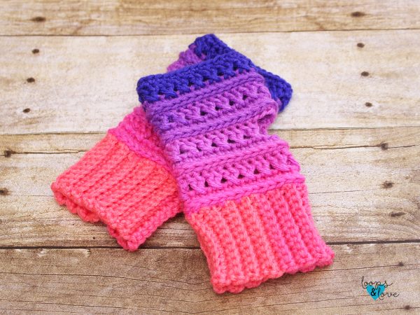 a pair of crochet fingerless gloves on wooden background