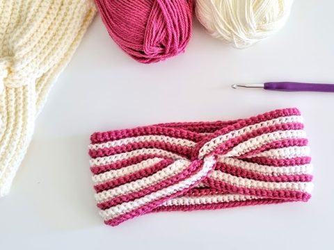 crochet twisted headband with red and white stripes on white background