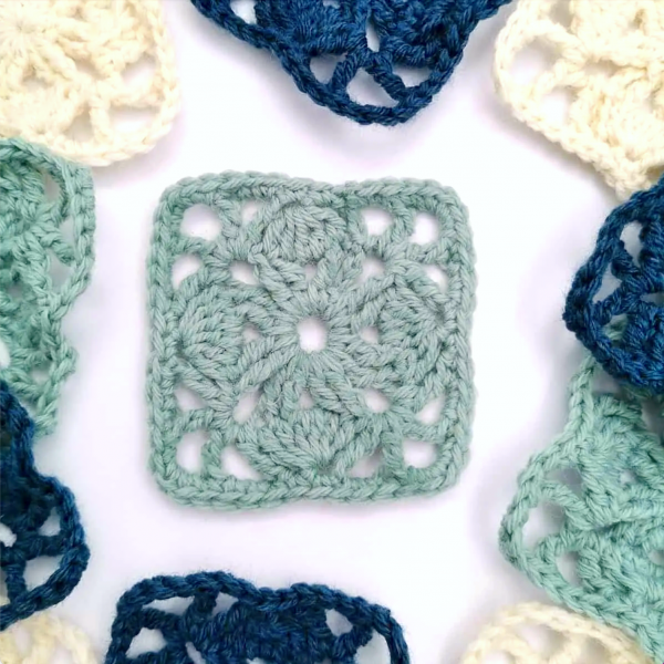 green crochet square on white background 