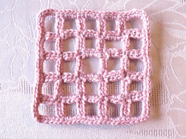 pink crochet square on pick background