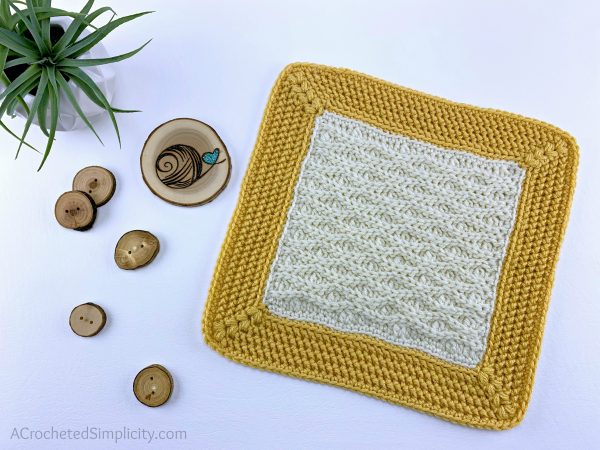 crochet square in natural and gold colours on white background