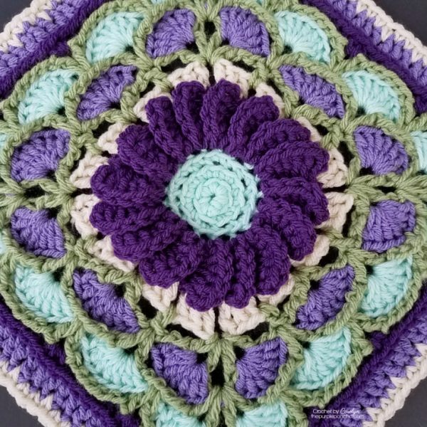 unusual unique crochet granny square with purple 3d flower in the centre 
