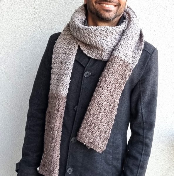 A man wearing a crochet scarf