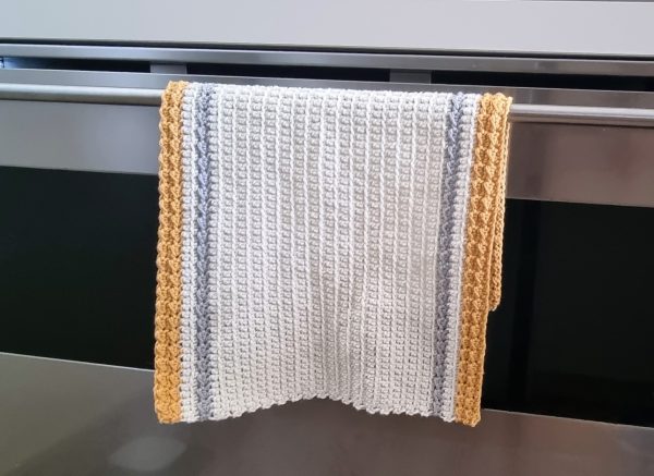 Kitchen crochet towel hanging on the oven handle