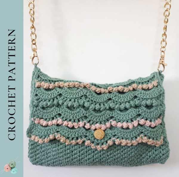 green crochet purse with a golden chain handle on a white background 