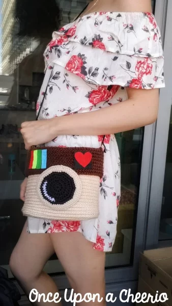 woman in a white flower dress with a crocheted purse over her shoulder