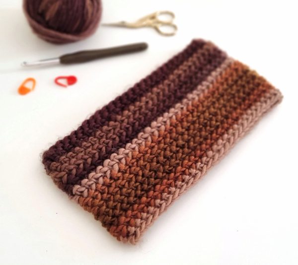 A brown crochet headband for men, showcasing a textured pattern with a stylish and comfortable design.